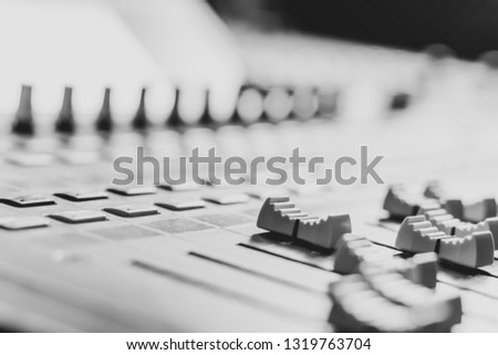 mixing console fader, black and white. music production, recording, broadcasting concept