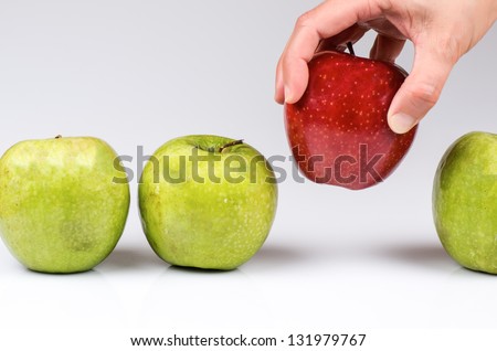 photograph of a hand picking apples to choose Royalty-Free Stock Photo #131979767