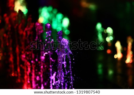 Colorful water with lights in fountain
