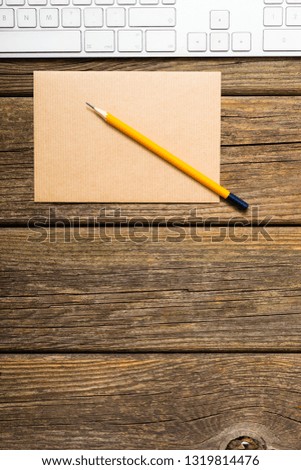 place of work, recycled paper, pencil, keypad, old wooden table background