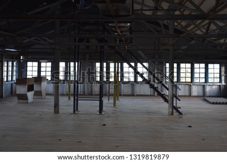 Old Factory Godown made of wood and steel with staircase and rooftop  Royalty-Free Stock Photo #1319819879