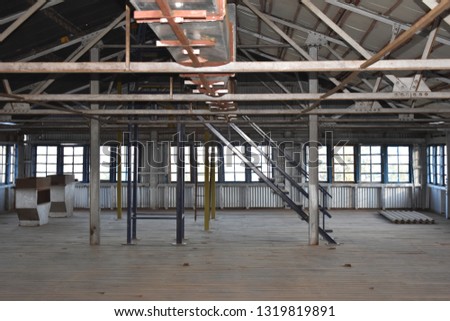 Old Factory Godown made of wood and steel with staircase and rooftop  Royalty-Free Stock Photo #1319819891