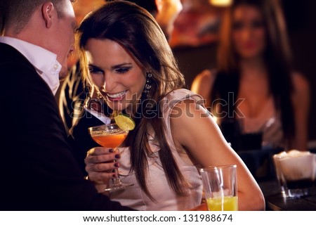 Happy couple at the bar enjoying the cocktail party Royalty-Free Stock Photo #131988674