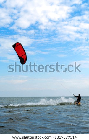 Kitesurfing Kiteboarding action photos man among waves quickly goes.