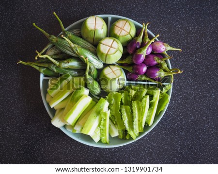 Local Thai vegetable set including white and green Thai eggplants, purple Thai eggplants, winged beans and cucumber