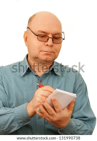 a middle-aged man in a blue shirt with a notebook and pen in hand, isolated on white background.