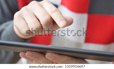 Man hand touching screen on modern digital tablet pc. Close-up image with shallow depth of field. Concept of modern gadgets in use