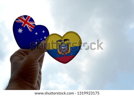 Hand holds a heart Shape Australia and Ecuador flag, love between two countries