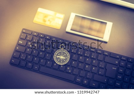 Web business: Arrangement of keyboard, compass, credit card and smartphone