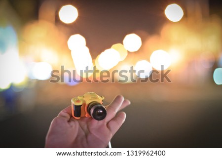 Tiny camera with blurred background at night