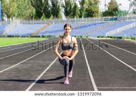Warm up the girl before running, stretching training in running stadium. People sport and fitness concept.