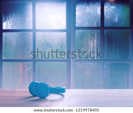 On a rainy day, see the water drops on the outside mirror blurred. (rainy day window background)
On table, there is a headphone for opening music on the left.
Feelings, sadness, loneliness, nostalgia.