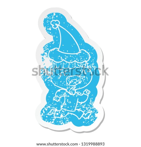 quirky cartoon distressed sticker of a happy boy laughing and running away wearing santa hat