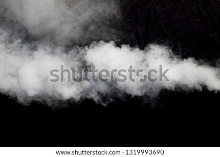 smoke blowing against dark background