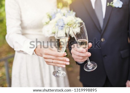 Groom and bride Toast and clinking glasses at the wedding party