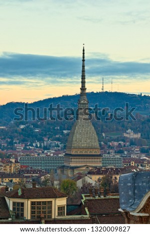 Aerial view from the bell tower of the Cathedral towards the Mole Antonelliana with background on the hills beyond the river Po, at sunset, Turin, Piedmont, Italy
