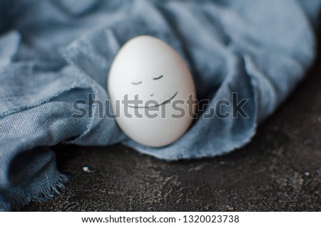 white egg with a smile. Easter concept.