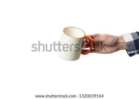 white mug for drawing an image on it in a female hand on a white background