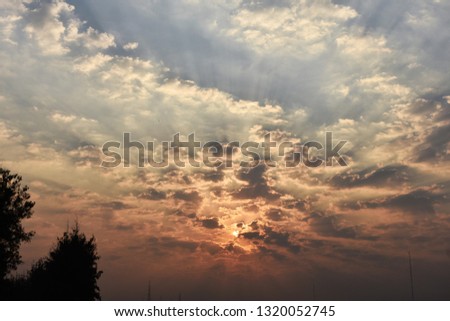 tropical golden blue sky white fluffy clouds during sunrise
