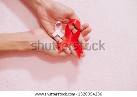 Cancer awareness hand ribbon top view, vintage picture style donate healthcare concept.
