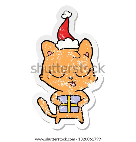 cute hand drawn distressed sticker cartoon of a cat wearing santa hat