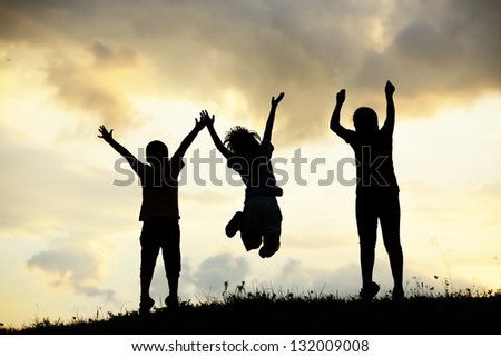 Active group of kids spending happy time on summer sunset at meadow