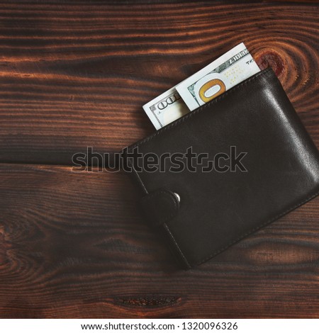Dollars on a wooden background. Money in your wallet