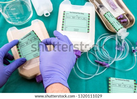 Nurse placed label on bottle of enteral nutrition, palliative care in hospital, conceptual image, composition hotizontal