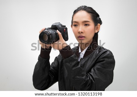 Photographer hold camera with lens point to shoot subject, wear normal dark black leater suit jacket. studio lighting white gradient grey background isolated, reporter journalist take photo celebrity