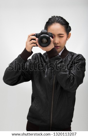 Photographer hold camera with lens point to shoot subject, wear normal dark black leater suit jacket. studio lighting white gradient grey background isolated, reporter journalist take photo celebrity
