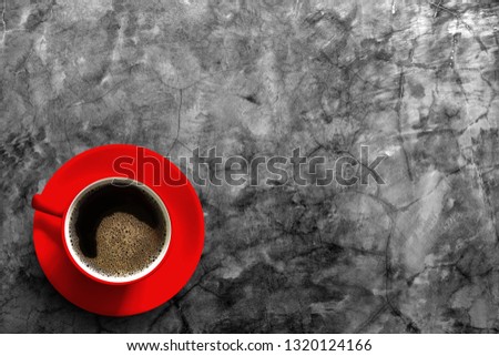 Red coffee cup on the cement table
