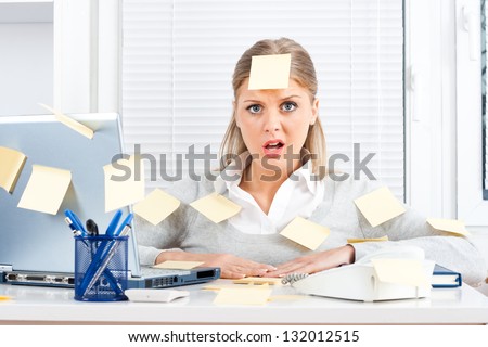 Young businesswoman with too much work to do,Overworked Royalty-Free Stock Photo #132012515
