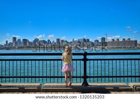 summer travel tourist little girl enjoying view of old port skyline from Montreal park living a happy lifestyle walking during Canada vacation. enjoying season banner panorama.