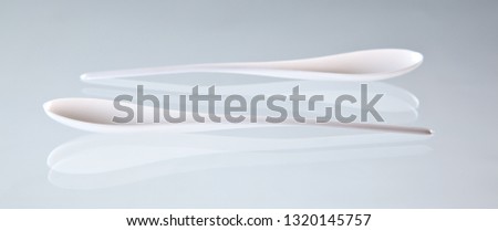 White elegant spoons for catering with the white background