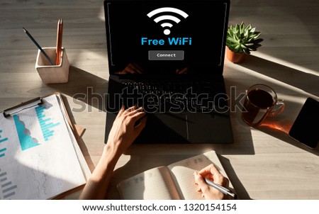 Free wifi connection on device screen. Internet and wireless technology concept.