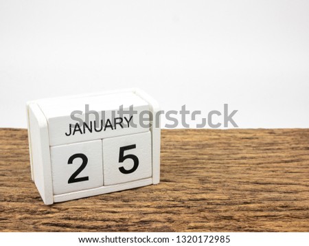 January 25 white cube wooden calendar on vintage wood and white background with winter day, Copyspace for text.