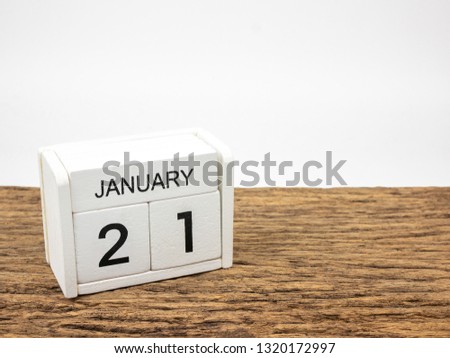 January 21 white cube wooden calendar on vintage wood and white background with winter day, Copyspace for text.