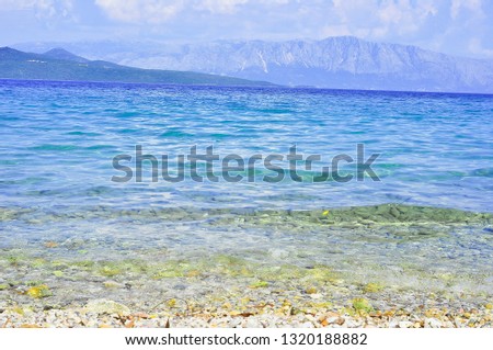 Blue sea water on Mediterranean sea on sunset time with rocks around. Landscape sea photography.