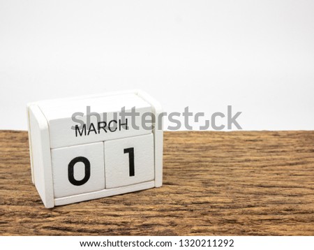 March 1 white cube wooden calendar on vintage wood and white background with Spring day, Copyspace for text.