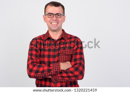 Portrait of happy hipster man with arms crossed