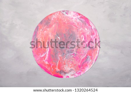 Fluid acrylics art picture. Pouring acrylic paint in pink colors on grey background. Creative artwork.