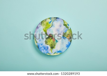 top view of planet picture on turquoise background, earth day concept
