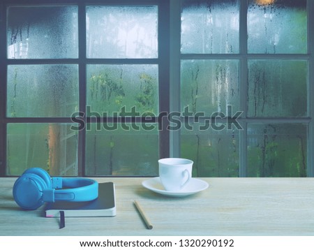 On a rainy day, see the water drops on the outside mirror blurred. (a rainy day window background)
On the table, there is a headphone for opening music on the left.
Feelings, sadness, loneliness