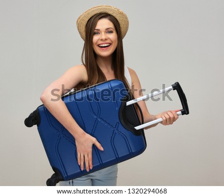 smiing girl wearing summer hat standing with her suitcase for vacation travel. Royalty-Free Stock Photo #1320294068