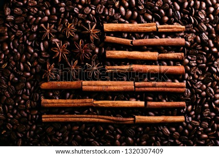 Coffee beans and star anise and cinnamon in the shape of the American flag. Fragrant spices for coffee drink, close-up, concept americano.