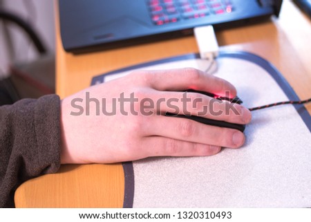male hand is holding a computer mouse
