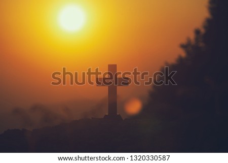 The cross of christian standing with light sunset background. christian silhouette concept.