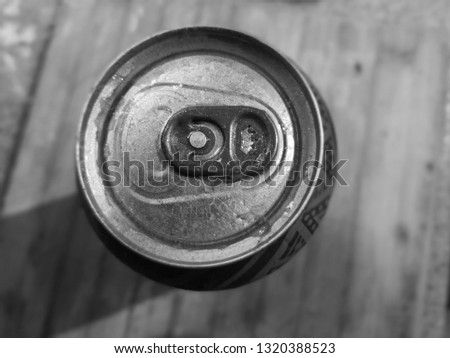Monochrome picture featuring top view of soda can