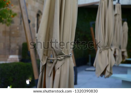 close up of closed umbrellas of a cafe