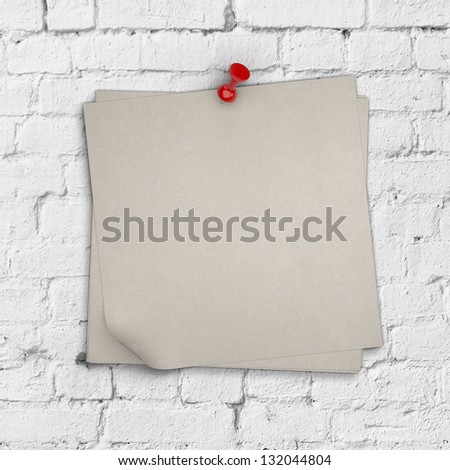 note paper pinned on brick wall